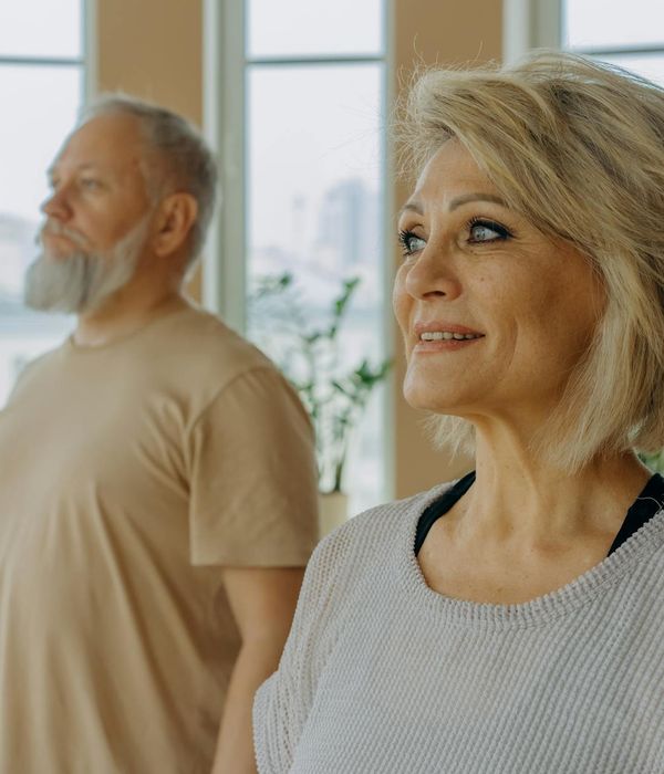Person practicing a calm yoga pose in a bright room.